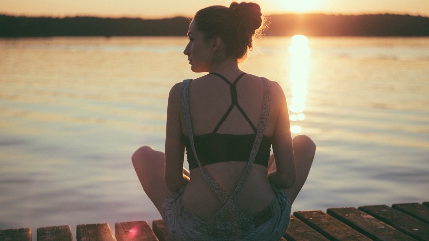 girl in a bench on the lake, unspolit nature 