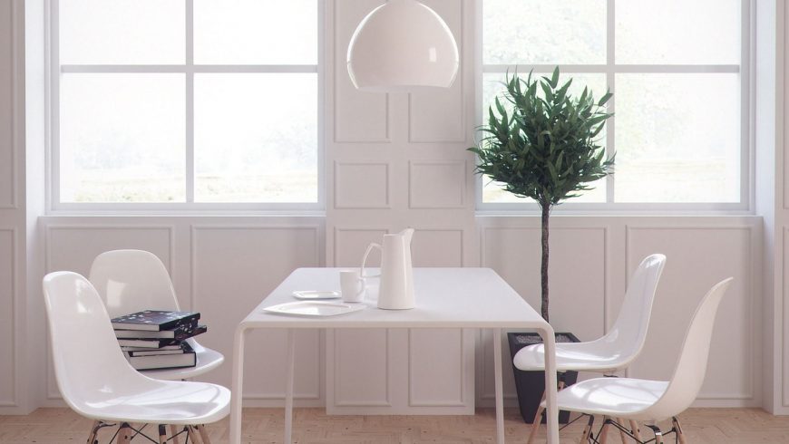 Stanza minimalista, con tavolo, sedie e lampada bianchi