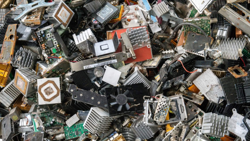 Cumulo di rifiuti elettronici RAEE con dispositivi dismessi come smartphone e computer, simbolo dell’inquinamento tecnologico e del riciclo delle terre rare.