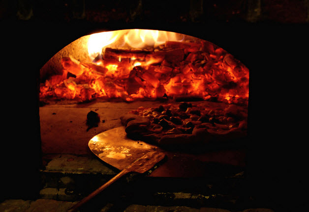 A mushroom and olive pizza in the wood oven