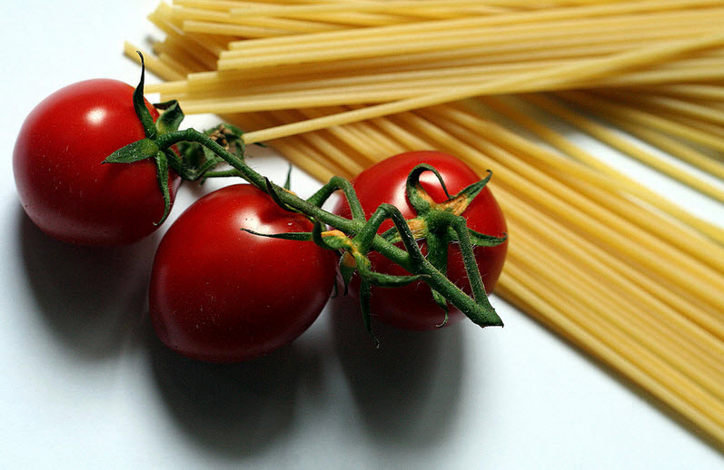 Some raw durum wheat spagetti an dsom ered cherry tomatoes