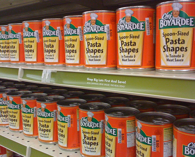 Some cans of psta on a grocery store shelf