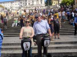 Two people standing on their segways in front of Piazza di Spagna in Rome