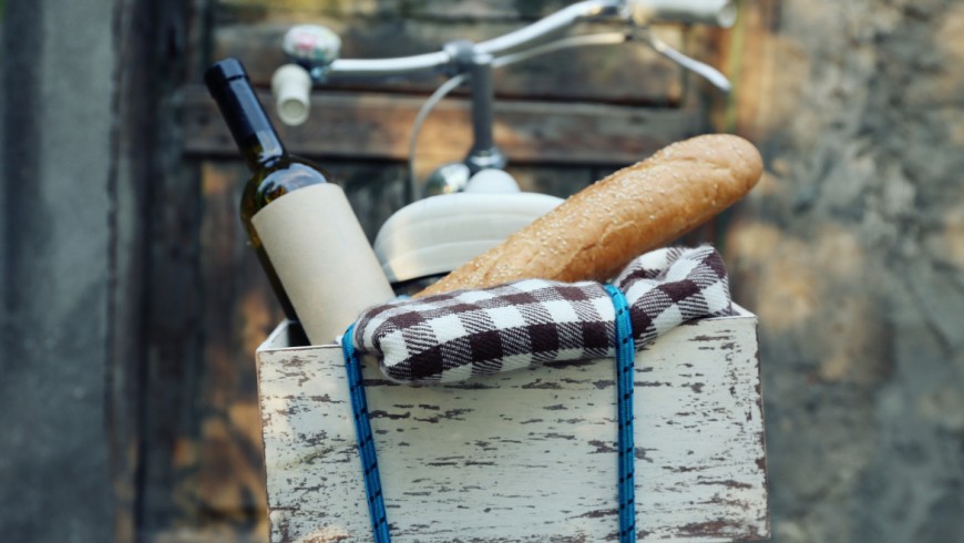 Eco-Picnic Bicycle with picnic snack in wooden box on old wooden door background