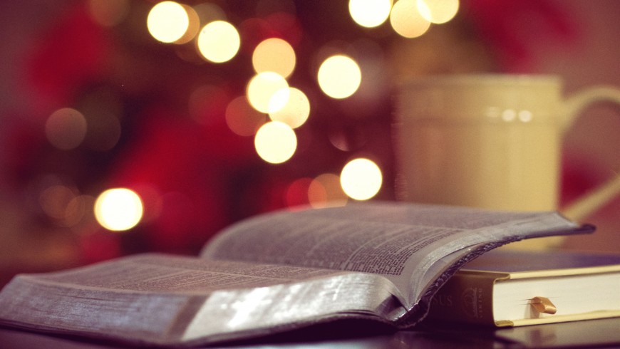 Open book with Christmas' lights, green Christmas, photo by Aaron Burden via Unsplash