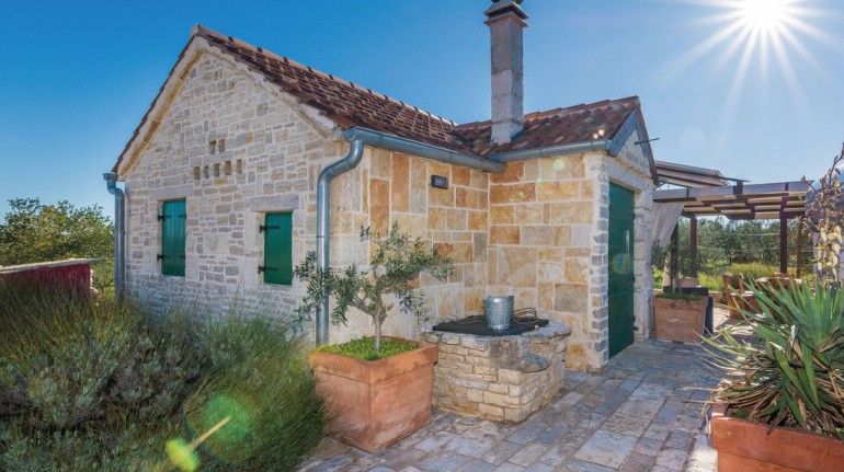 Entrance of the house seen from outside. The tank is visible