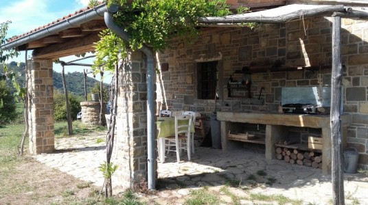 The porch on the side of the house, with a barbecue