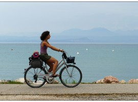 lady with bycycle by the sea slow tourism