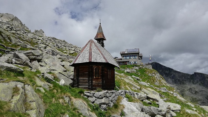 Church surrounded by rocky mountains and alpine refuge 