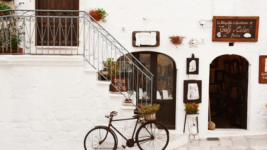bike parked near a white charming house