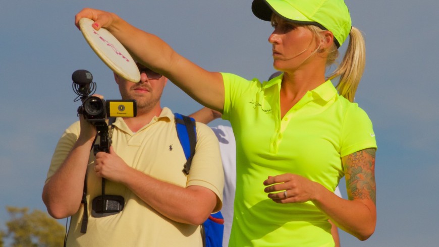 A Disc Golf player with her frisbee