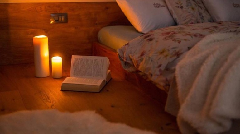 Photo: cozy evening reading. Source: eco chalet Astra Montana