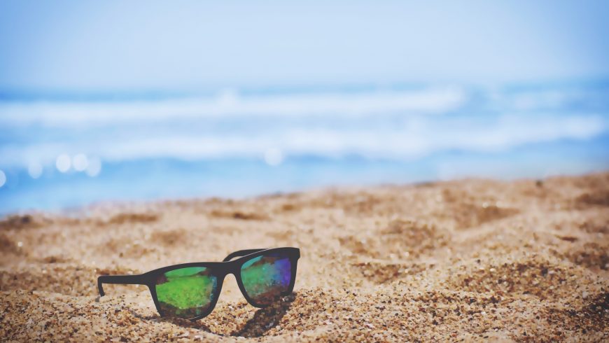 sunglasses lying on the beach 