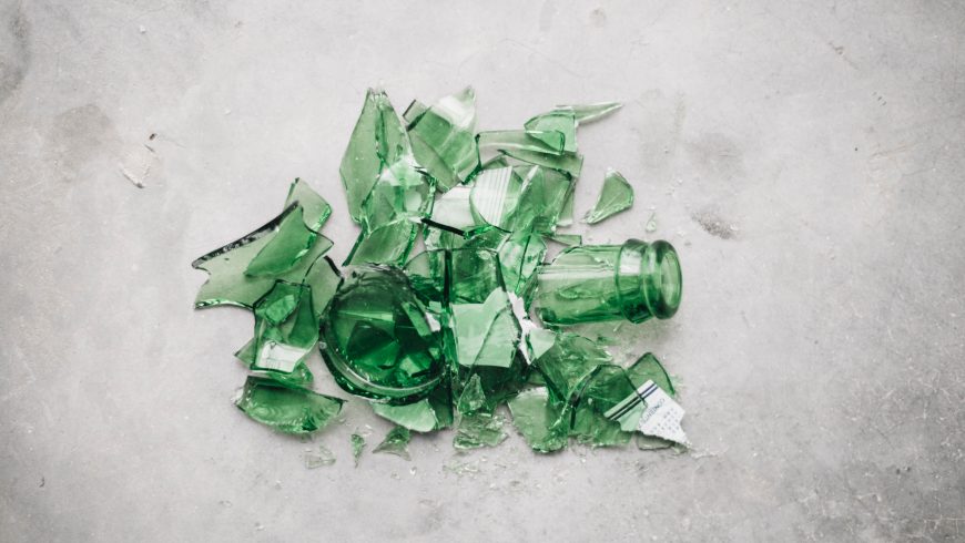 broken green glass bottle on the ground
