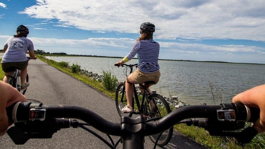 People riding their bike along the coastline