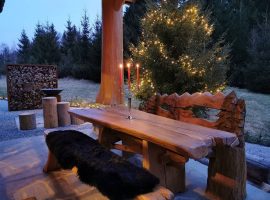 Charming wooden table on the courtyard of Divjake Log Home