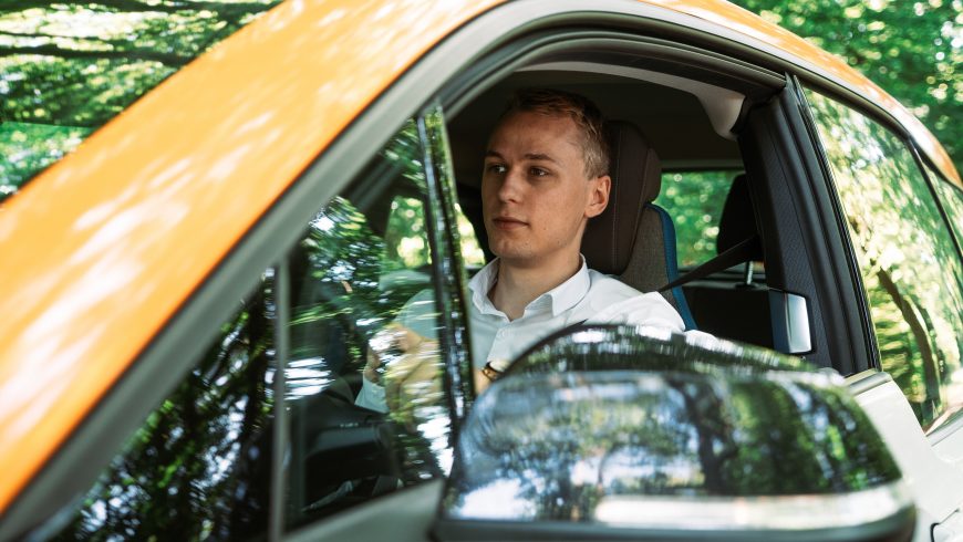 man driving an electric vehicle