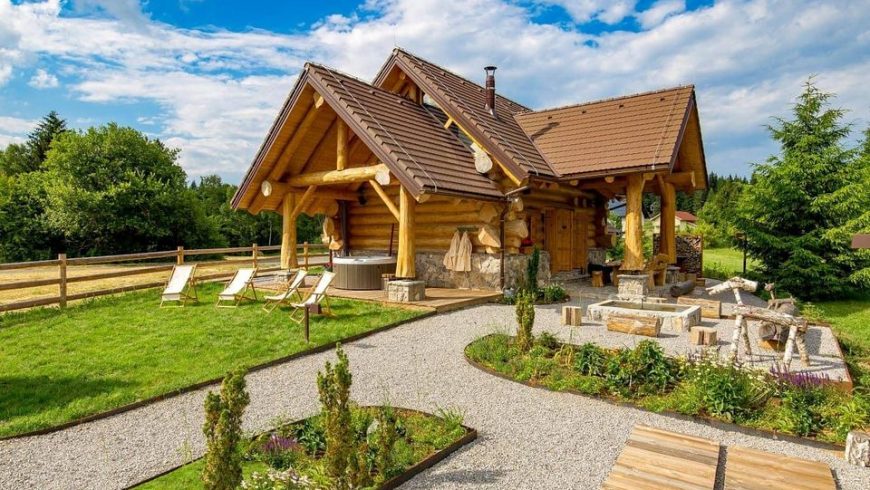 Exterior of Divjake Log Home eco chalet in Croatia, on a sunny day.