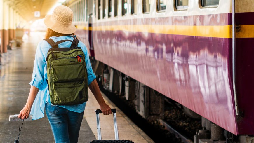 Sustainable traveler: Solo woman backpacker traveler plan safety trip low cost budget summer holiday after coronavirus. Empty tourists on train railway platforms. Use bus train sustainable environmental friendly transport