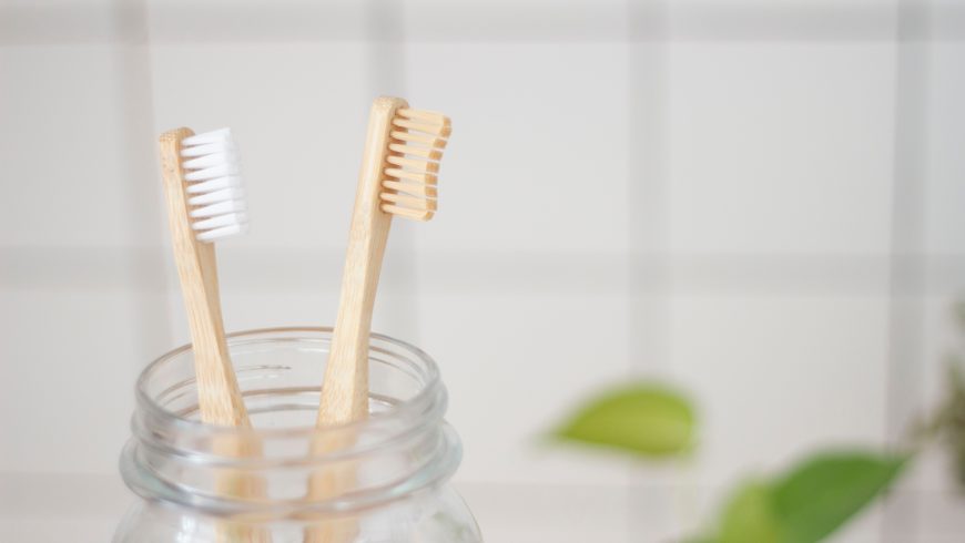 Two eco toothbrushes in a mason jar.