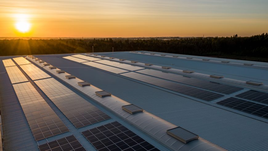 Solar panels on a roof during a sunset.