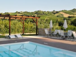 the pool with views on the landscape in Agriturismo La Curtis