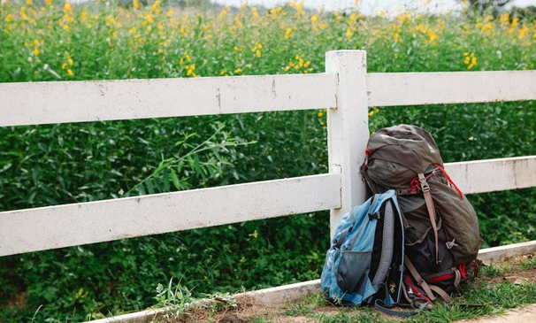 Rucksack leaned on a fence. 