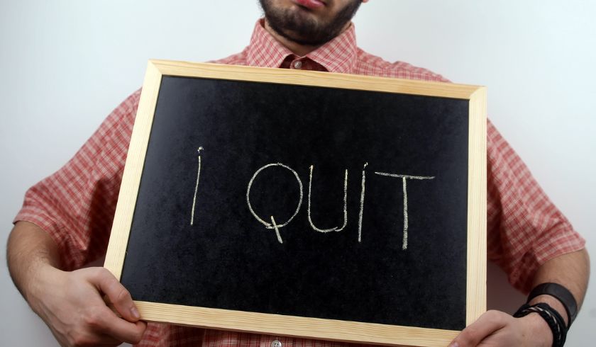 man wanting to climate quitting holds a chalkboard with the inscription "i quit"