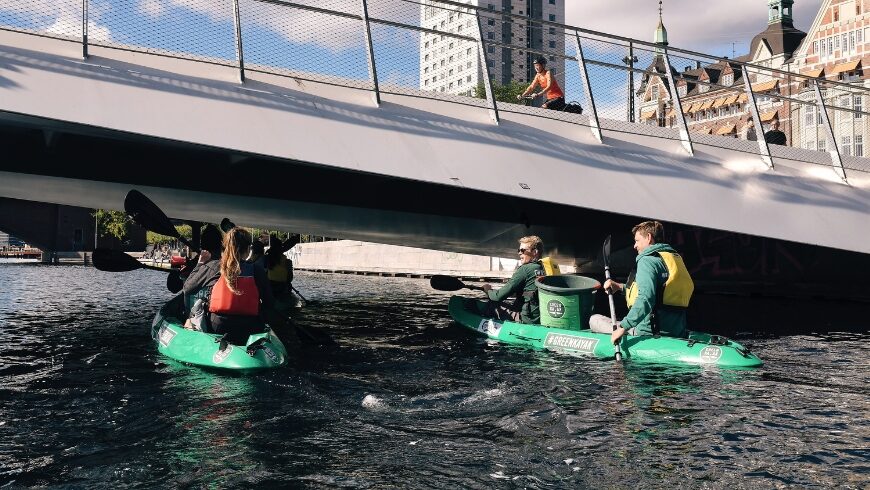 GreenKayak volunteers paddling in the water