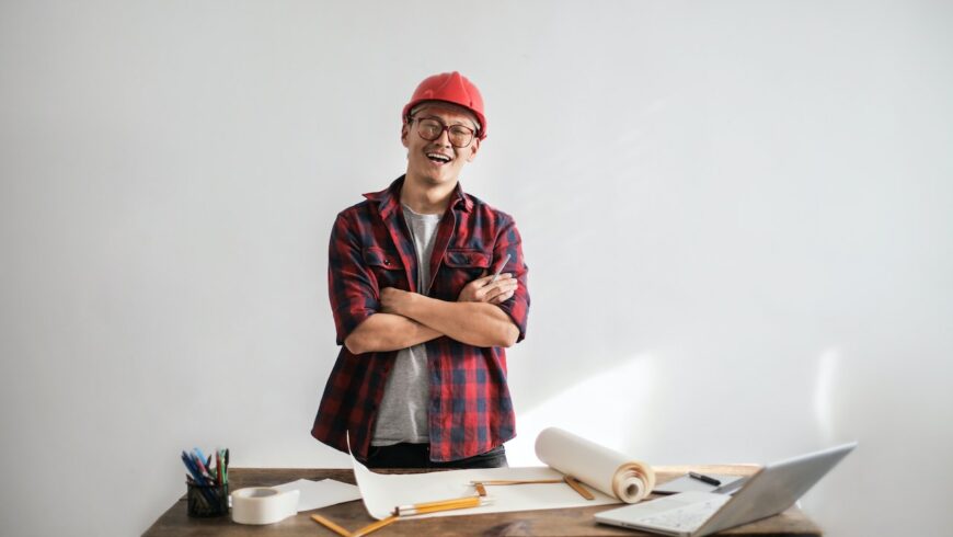 An ethnic constructor standing behind a table