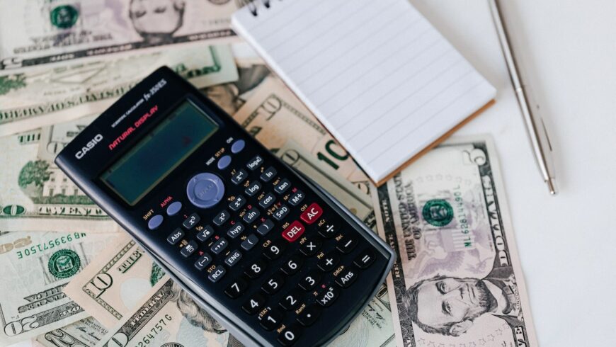 A calculator on dollar bills