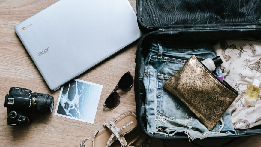 Things next to a suitcase while packing and using packing tips for the conscious traveler