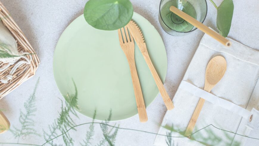 green plate and bamboo cutlery