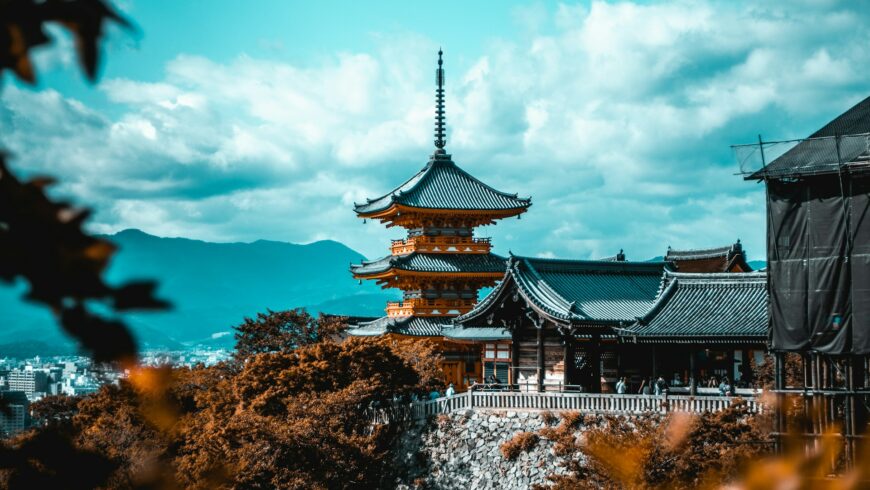 A temple in Kyoto, with the sky and the mountains in the background.