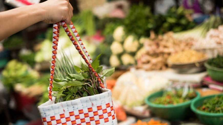 Tourists buying local food or handmade crafts from small vendors