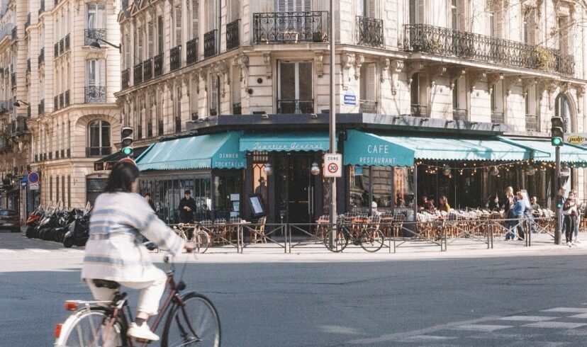 Woman on a bike crossing a street