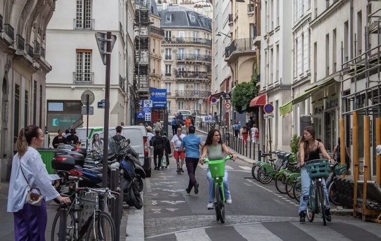 two girls on a bike in the centre of Paris in a car-free zone