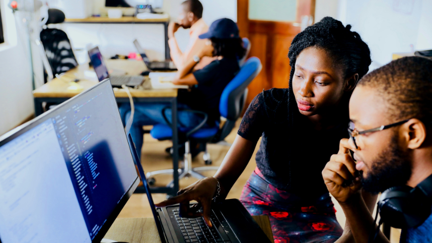 Two people learning and sharing knowledge about technology.
