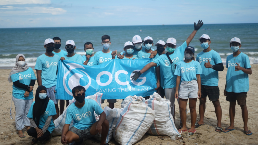 A team of volunteers cleaning the beach as part of the Saving the Ocean project.