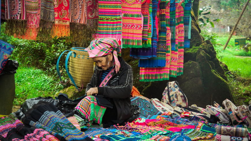woman selling traditional fabrics.