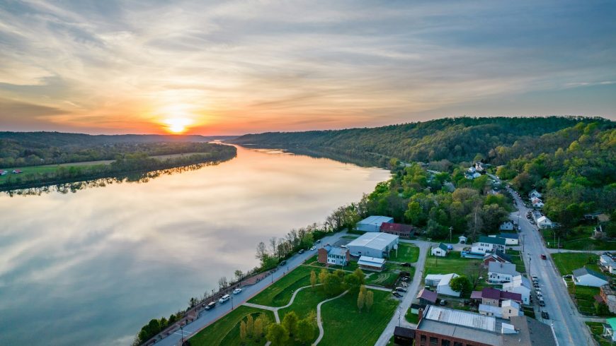 Aerial view of the Ohio River, sunset, forests, and buildings