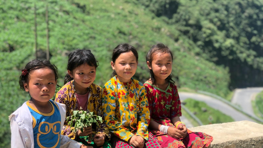 Local vietnamese children sitting along the roads of Ha Giang Loop