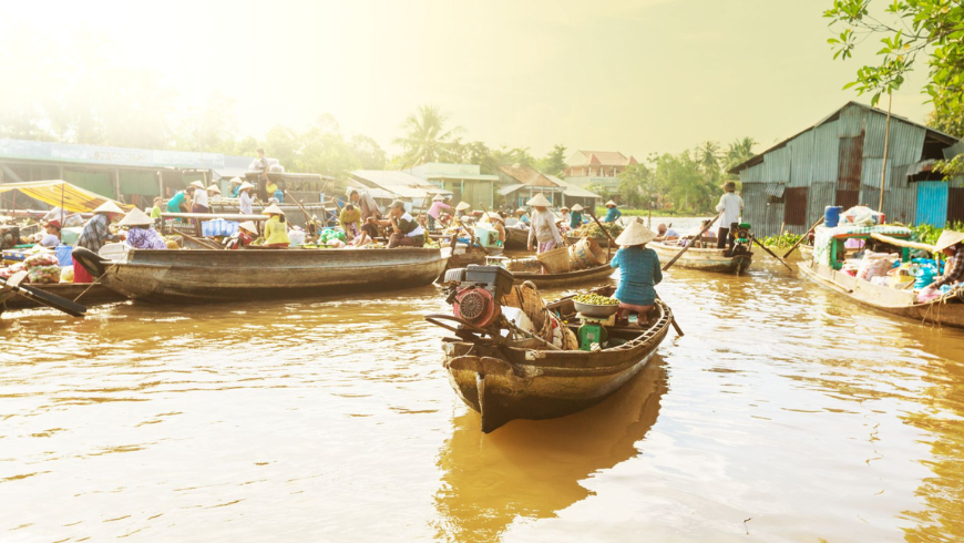 daily life at Mekong Delta people in their boats in the river 
