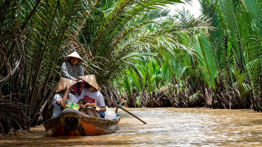 Three woman in a boat into the river 
