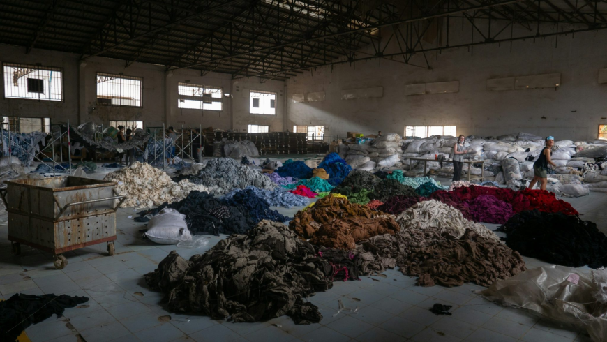 textile recycling warehouse with fabric scraps in the