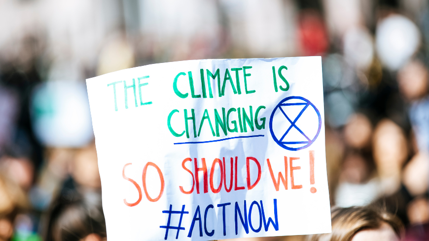 climate protest sign calling for climate action and environmental responsibility