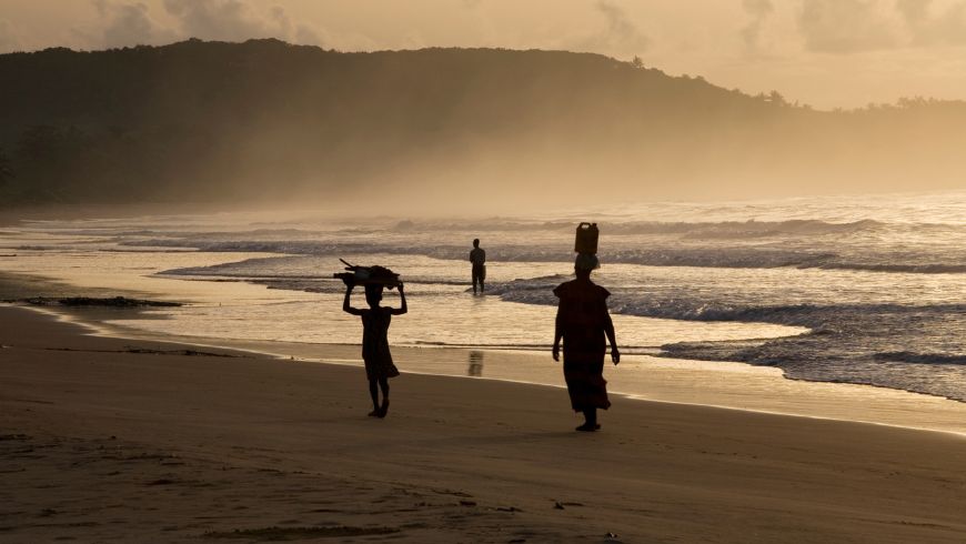 People walking on the beach in Ghana