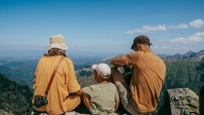 Family enjoying a mountain view in Valsassina with alpine peaks and paranomic landscape in northern Italy.
