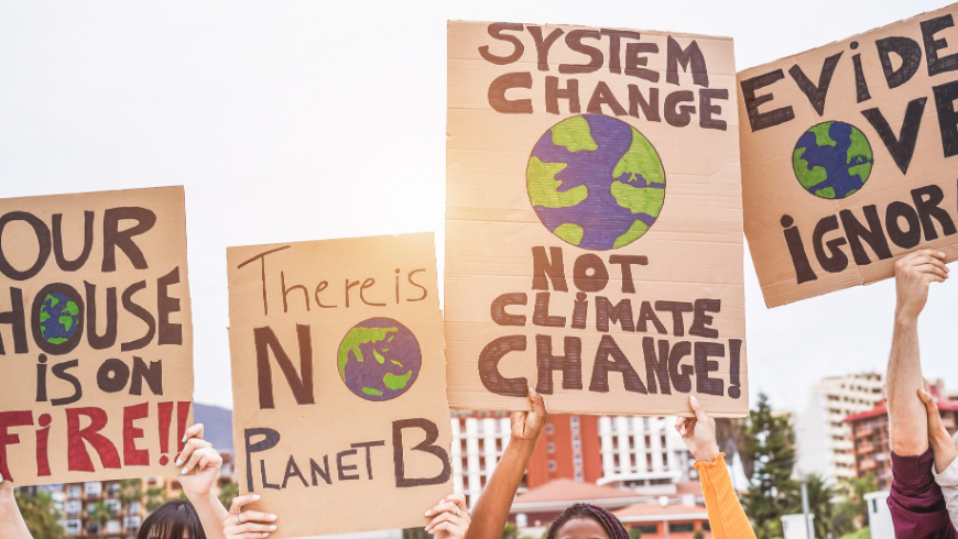 Group of demonstrators on road, young people from different culture and race fight for climate change - Global warming and enviroment concept - Focus on banners
