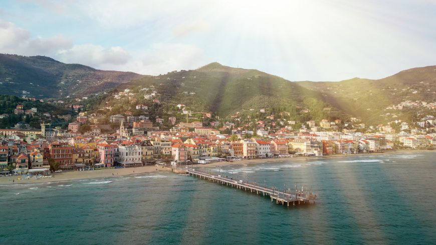 The view from the sea towards the town of Alassio and Mount Bignone 